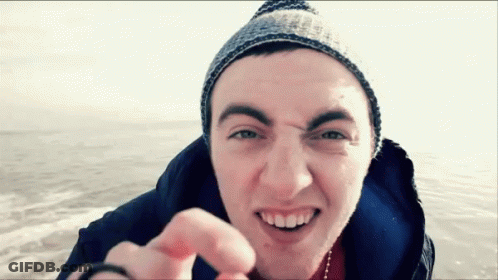 Young Man Beanie Jacket Smiling Pointing At Camera GIF