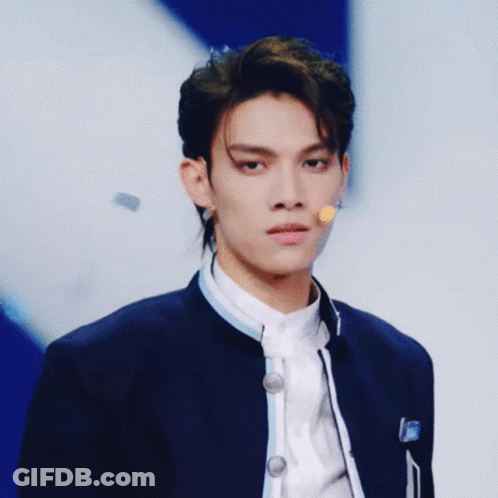 Young Man Blue Jacket Microphone Looking At Camera GIF