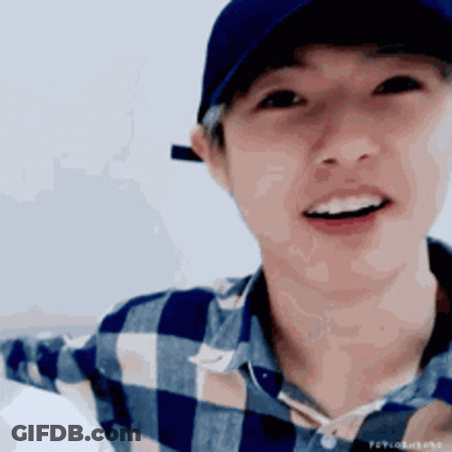 Young Man Close Up In Yellow And Green Shirt GIF
