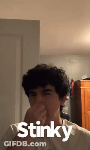 Young Man Covering Nose Saying Stinky GIF