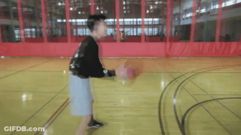 Young Man Dribbling Basketball On Court GIF