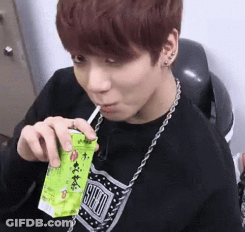 Young Man Drinking Through Straw From Box GIF