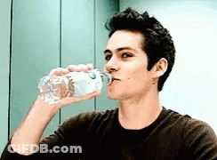 Young Man Drinking Water From Plastic Bottle GIF