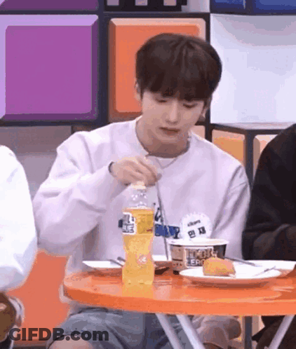 Young Man Eating At Table With Fork And Soda GIF