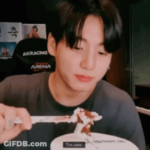 Young Man Eating Cake With Fork And Spoon GIF