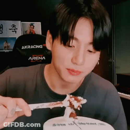 Young Man Eating Cake With Knife And Fork In Black Arena Shirt GIF