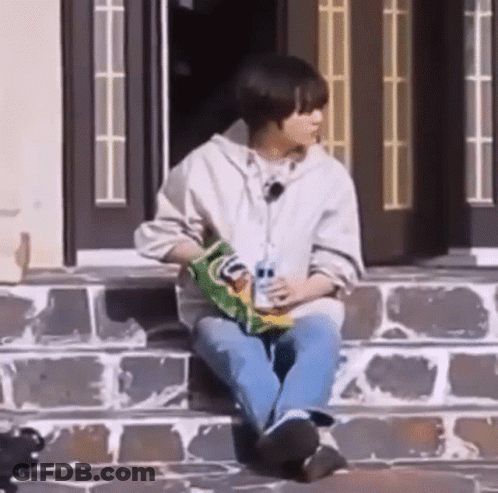 Young Man Eating Chips On Steps GIF