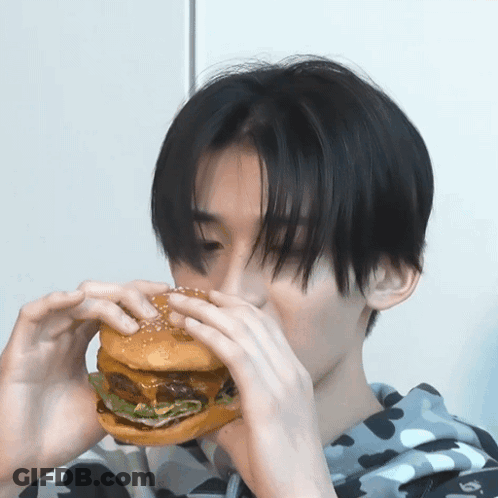 Young Man Eating Large Sesame Hamburger GIF