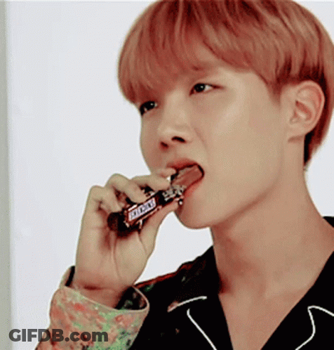 Young Man Eating Snickers Bar With Tongue GIF