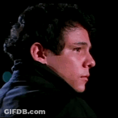 Young Man Face Close Up In Dark Room GIF