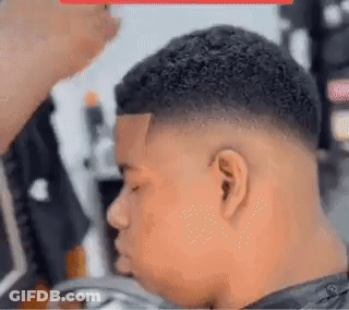 Young Man Getting Haircut At Barber Shop GIF