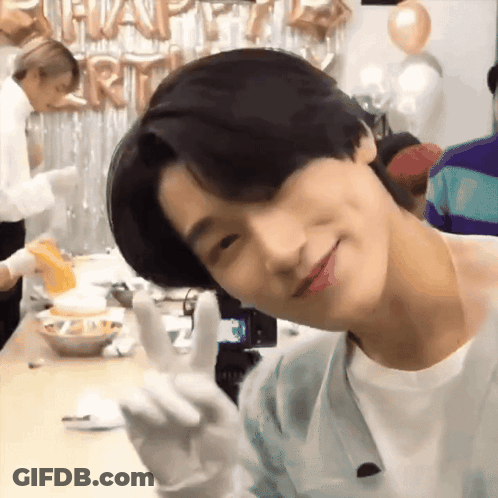 Young Man Giving Peace Sign With Balloons GIF