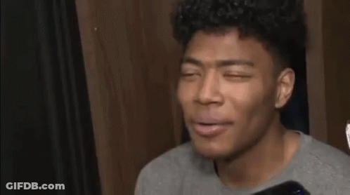Young Man Gray Shirt Phone Talks To Reporter GIF