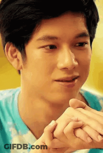 Young Man Holding Another Man's Hand Looking At Camera GIF