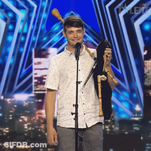 Young Man Holding Bagpipe At Espana Talent Sign GIF