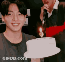 Young Man Holding Birthday Cake With Candle GIF
