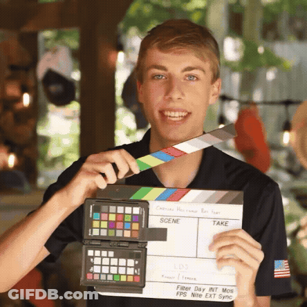 Young Man Holding Clapper Board GIF