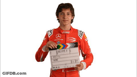 Young Man Holding Clapper Board With Kimi GIF