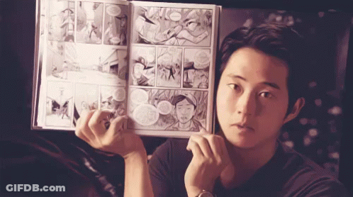 Young Man Holding Comic Book GIF