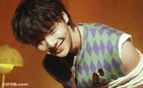 Young Man Holding Guitar Smiling Green Purple Vest GIF