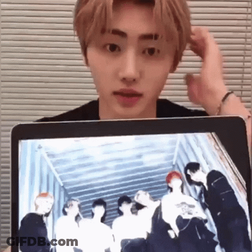 Young Man Holding Laptop With Group Photo On Screen GIF