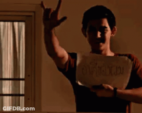 Young Man Holding Paper Making Devil Horns GIF