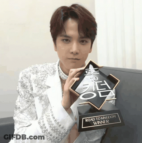 Young Man Holding Road To Kingdom Trophy GIF