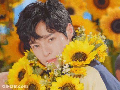 Young Man Holding Sunflowers Saying Osr GIF