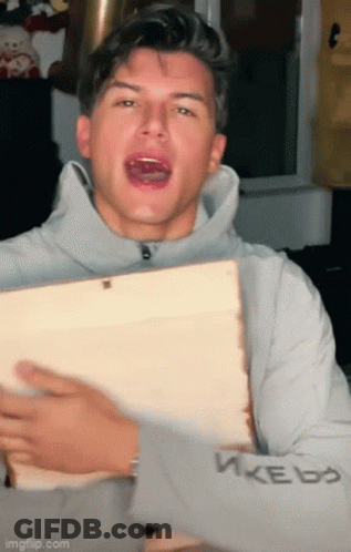 Young Man Holding Wood Making Funny Face GIF