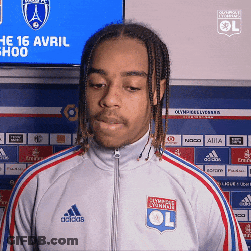 Young Man In Adidas Jacket At Olympique Lyonnais Sign GIF