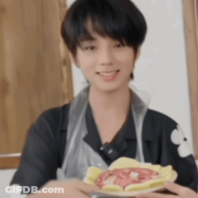 Young Man In Apron Holding Plate Of Food GIF
