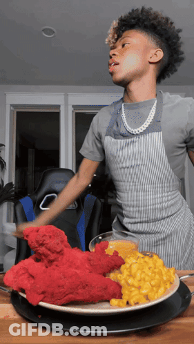 Young Man In Apron With Plate Of Food GIF