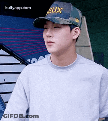 Young Man In Baseball Cap And Gray Sweater GIF