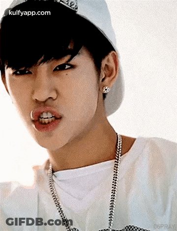 Young Man In Baseball Cap And Necklace Making Face GIF