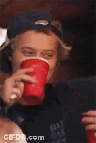Young Man In Baseball Cap Holding Red Cup GIF