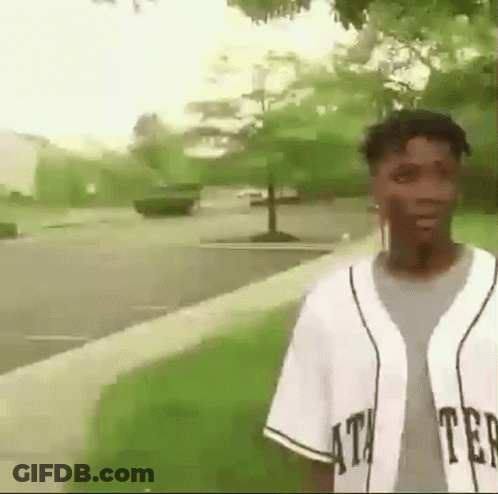 Young Man In Baseball Jersey On Sidewalk GIF