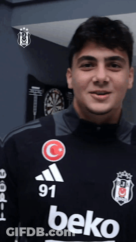 Young Man In Beko Jersey In Front Of Dartboard GIF