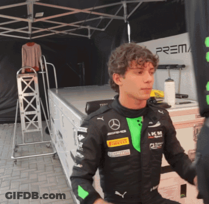 Young Man In Black And Green Mercedes Racing Suit GIF