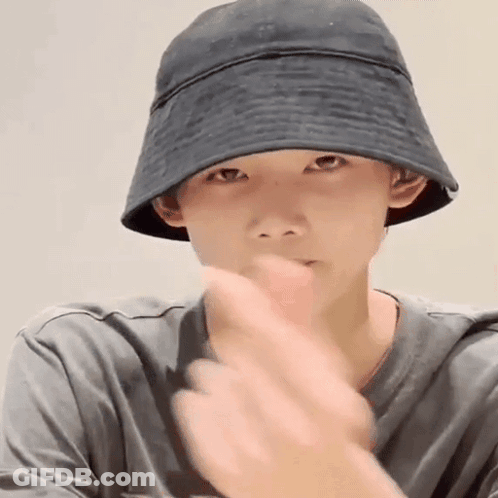Young Man In Black Bucket Hat And Grey Shirt Making Gesture GIF