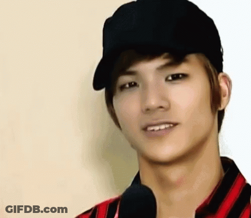 Young Man In Black Hat And Striped Shirt Smiling GIF
