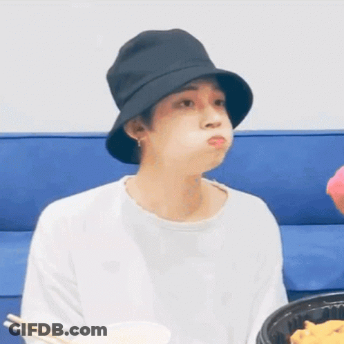 Young Man In Black Hat Eating On Blue Couch GIF