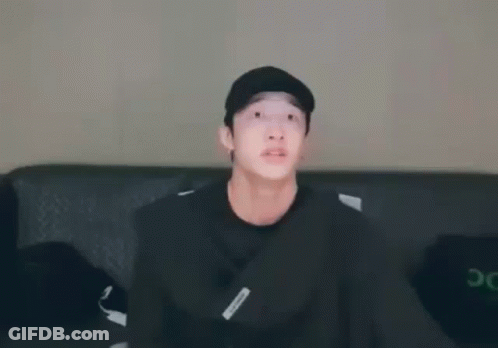 Young Man In Black Hat Sitting On Couch GIF