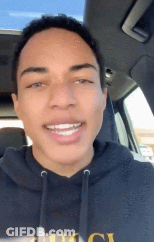 Young Man In Black Hoodie Smiling In Car GIF