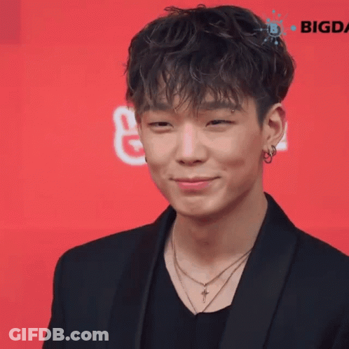 Young Man In Black Jacket And Cross Necklace Smiling GIF
