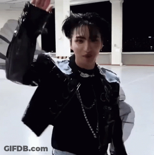 Young Man In Black Jacket And Necklace On Concrete Floor GIF