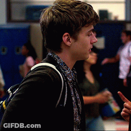 Young Man In Black Jacket And Paisley Shirt In Hallway GIF
