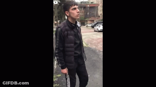 Young Man In Black Jacket Arms Outstretched GIF