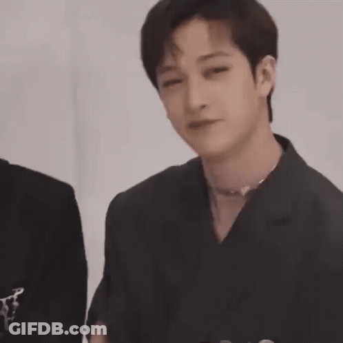 Young Man In Black Jacket Holding Hands To Chest GIF