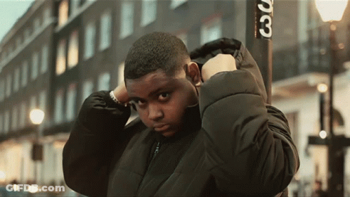 Young Man In Black Jacket In Front Of Sign Saying 30 GIF