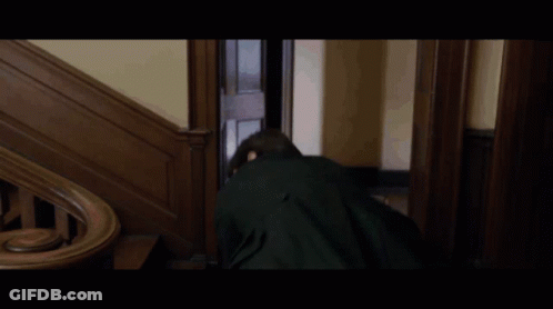Young Man In Black Jacket Walking Down Wooden Stairs GIF